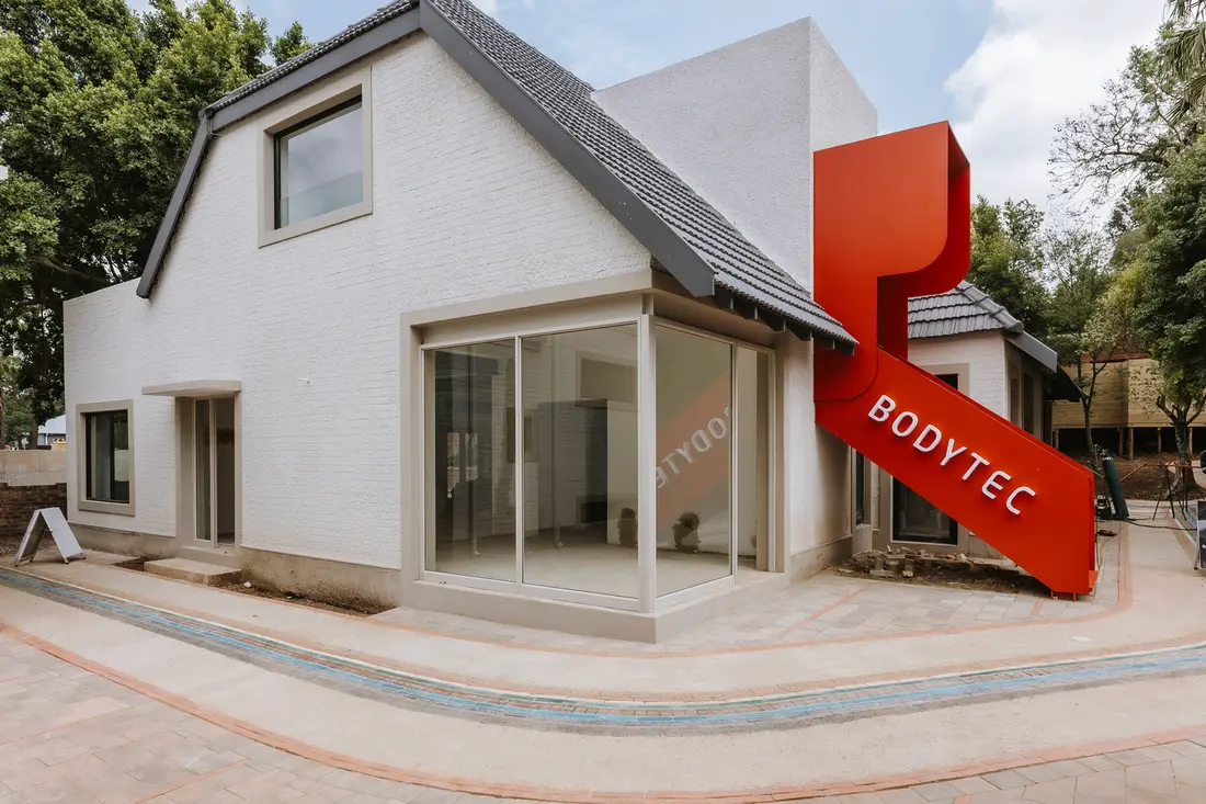 The BODYTEC building with its red ribbon sign