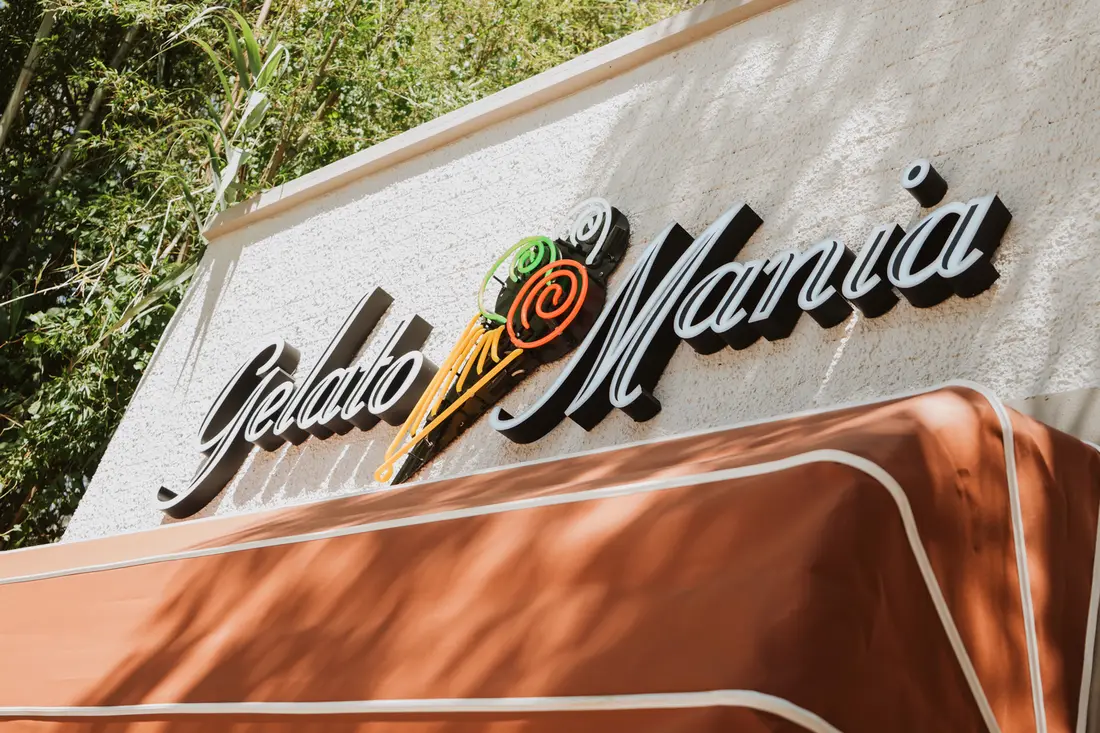 The Gelato Mania sign above an orange awning