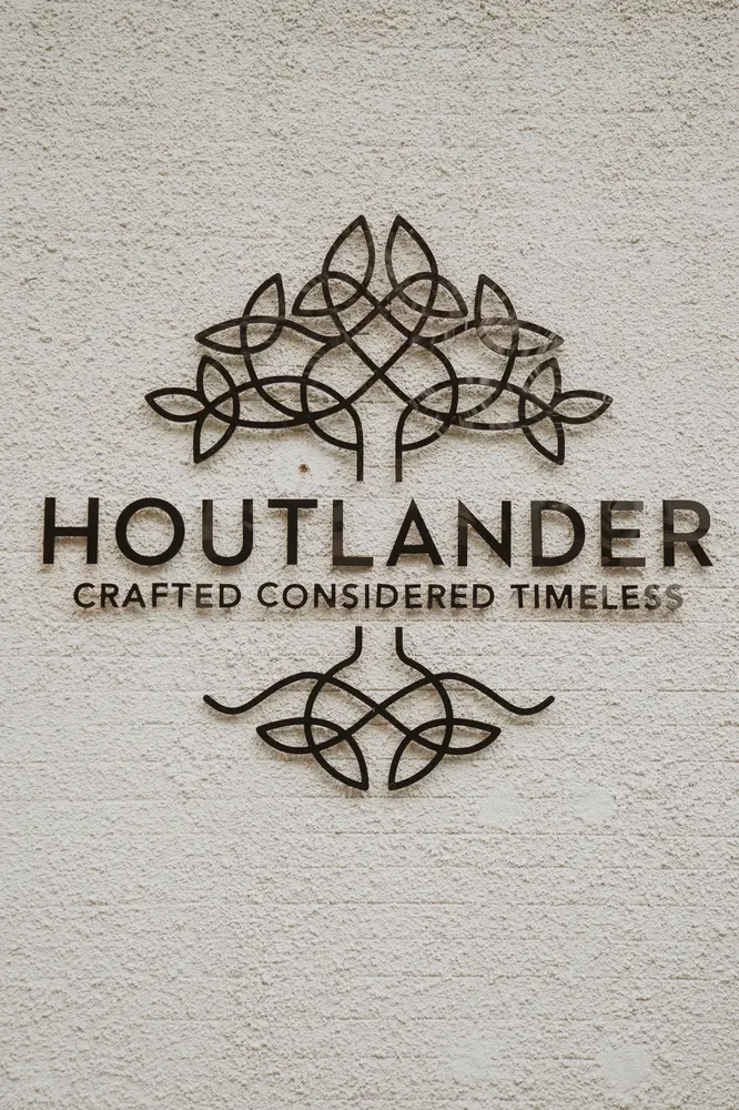 The Houtlander sign on a stucco wall