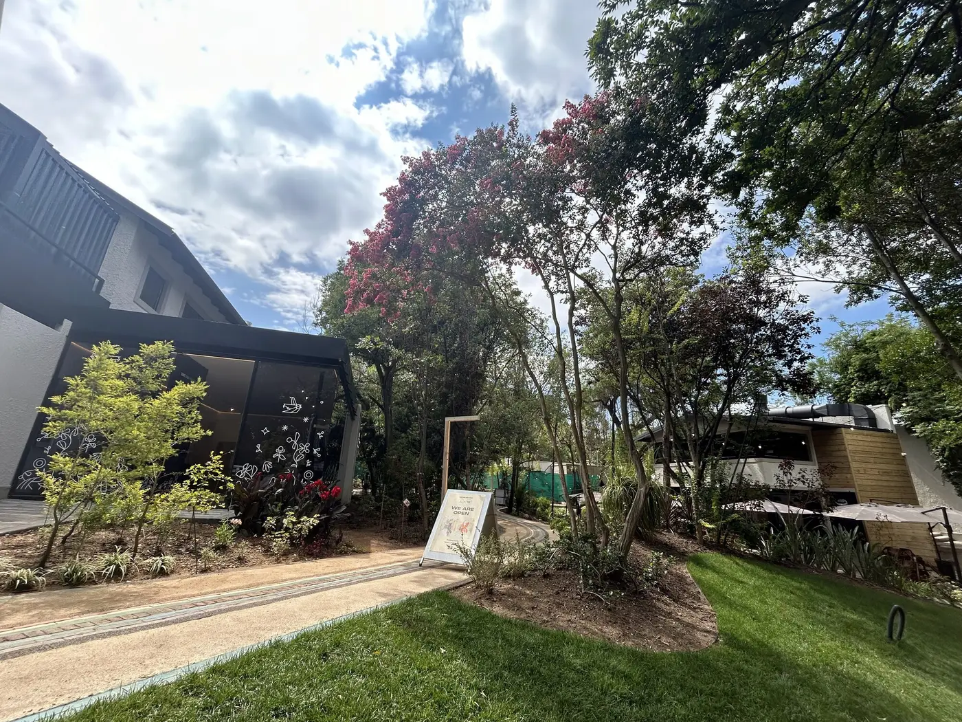 A pitched-roof building across a lawn at Nine Yards